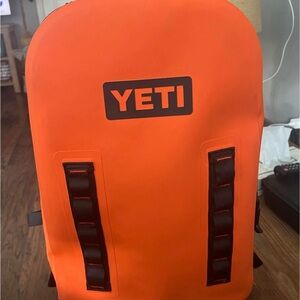 YETI Vibrant Orange Backpack with Black Details crab